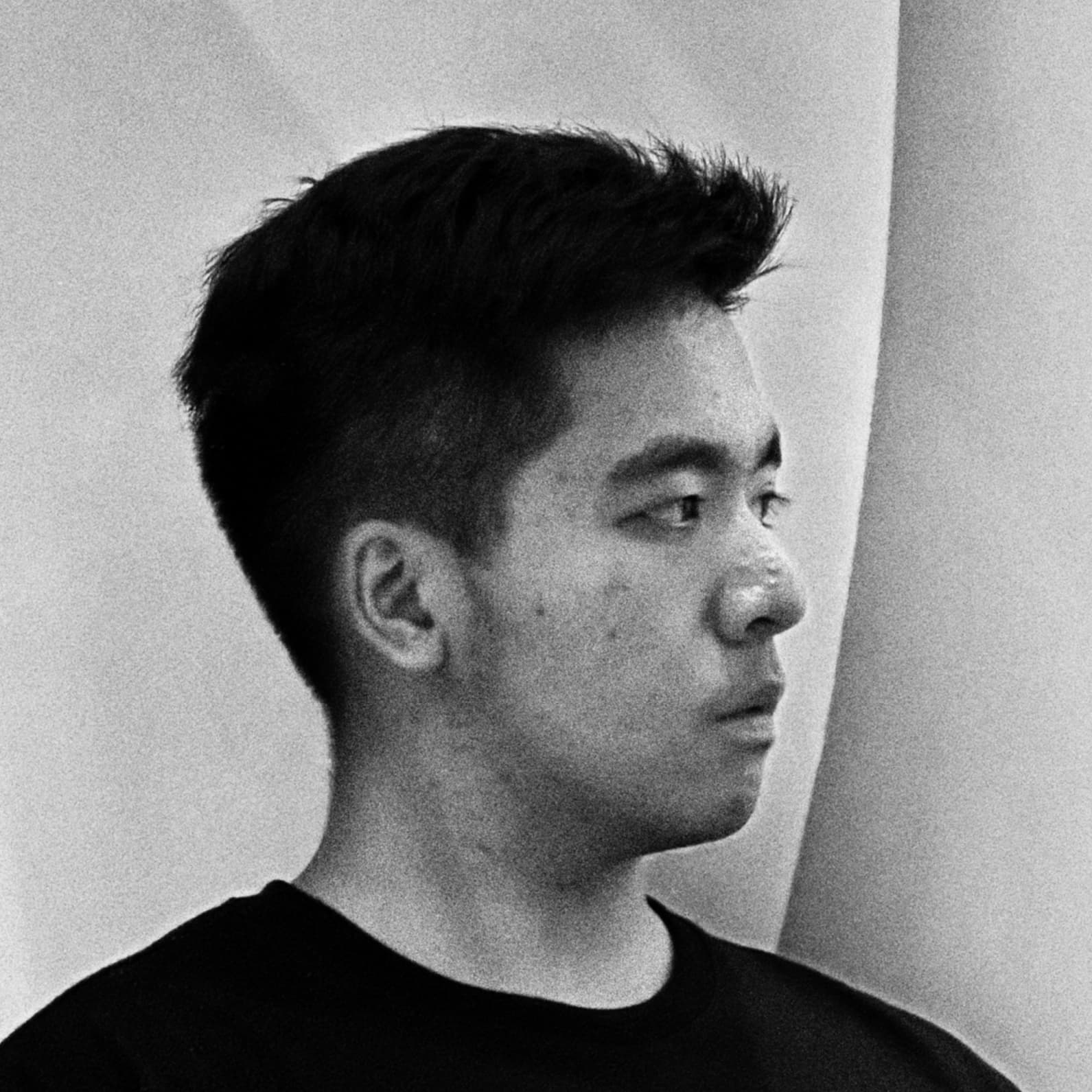 Portrait of Alfie Lin in profile